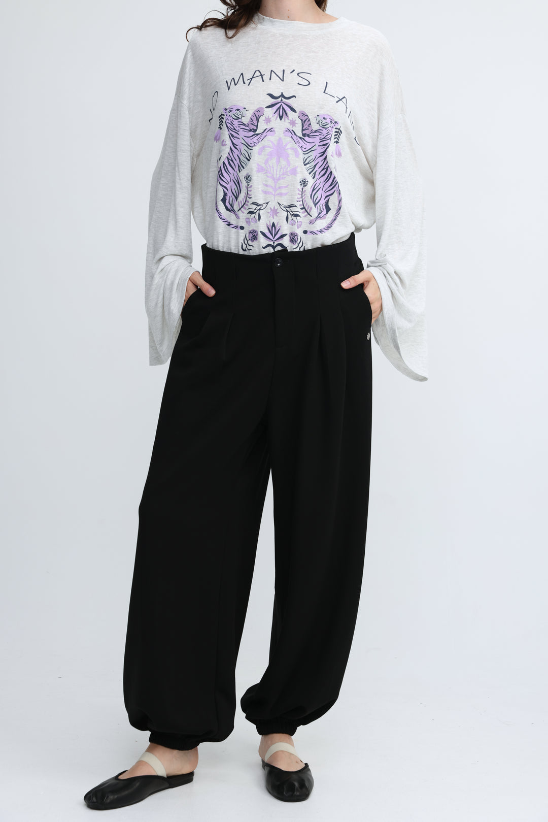 White long-sleeved top with purple tiger and floral graphic paired with everything black bottoms shown from front view