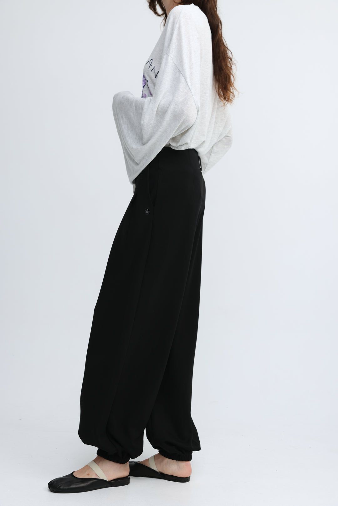 Black wide-leg pants with a relaxed flowing silhouette and elastic cuffs from Everything Black Bottoms shown front view