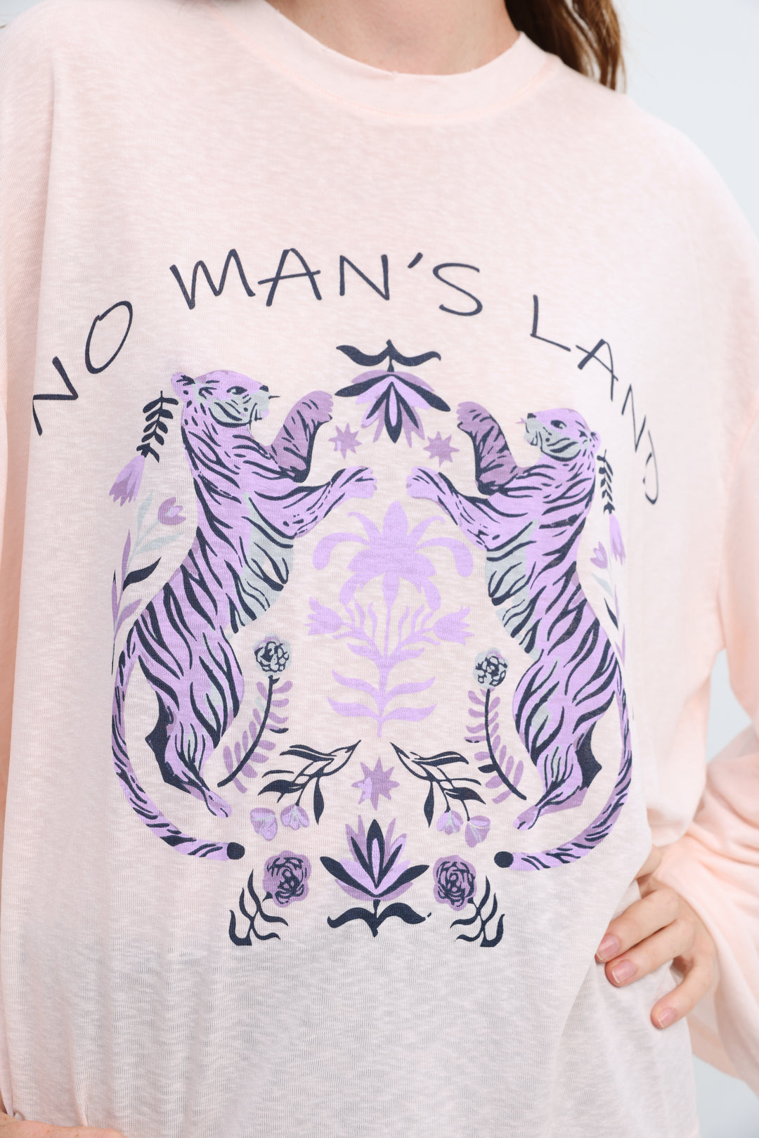 Nml pink shirt soft blush pink long-sleeved sweatshirt with purple tiger graphic and floral botanical illustrations front view