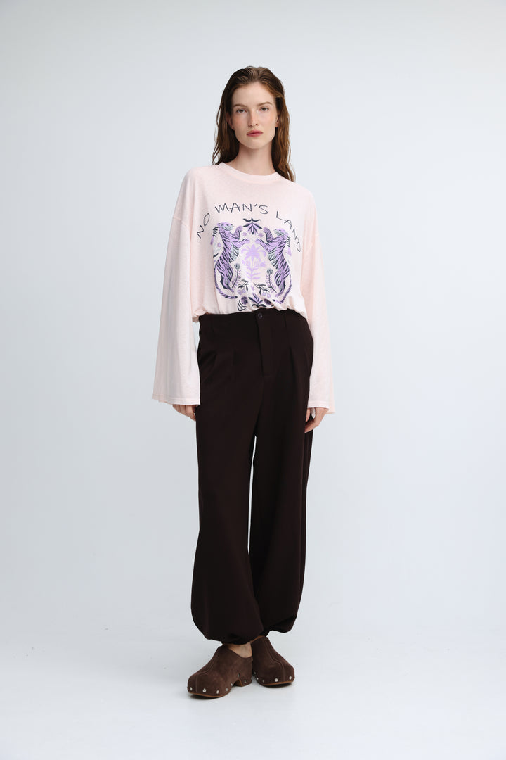 A pink long-sleeved sweatshirt with a purple and white tiger graphic and no mans land text on the front