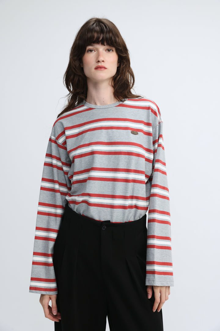 Gray and red horizontally striped long-sleeve crew neck top with small embroidered logo on left chest front view