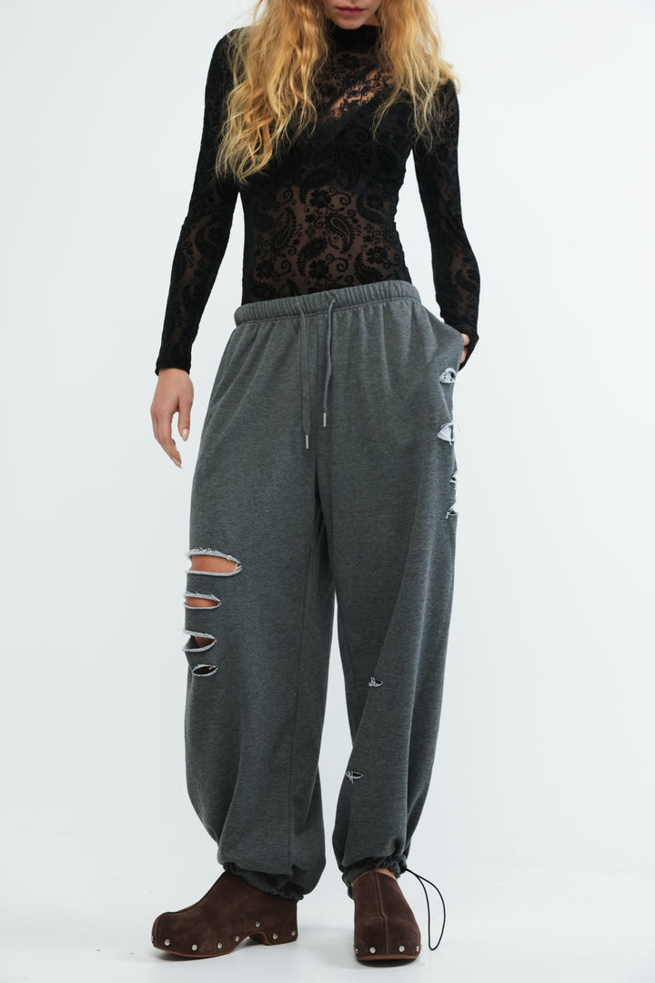 Scissors dark grey joggers with elastic waistband drawstring and distressed patches along the leg front view