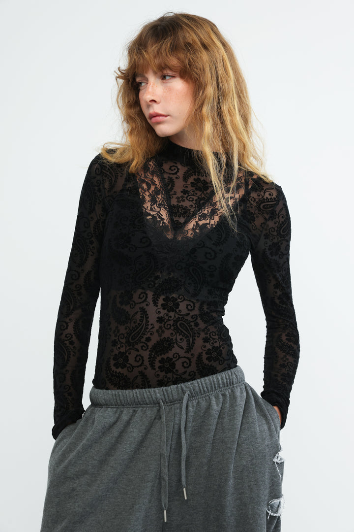 Claim black bodysuit featuring a long-sleeved top with intricate floral and paisley lace patterns in front view