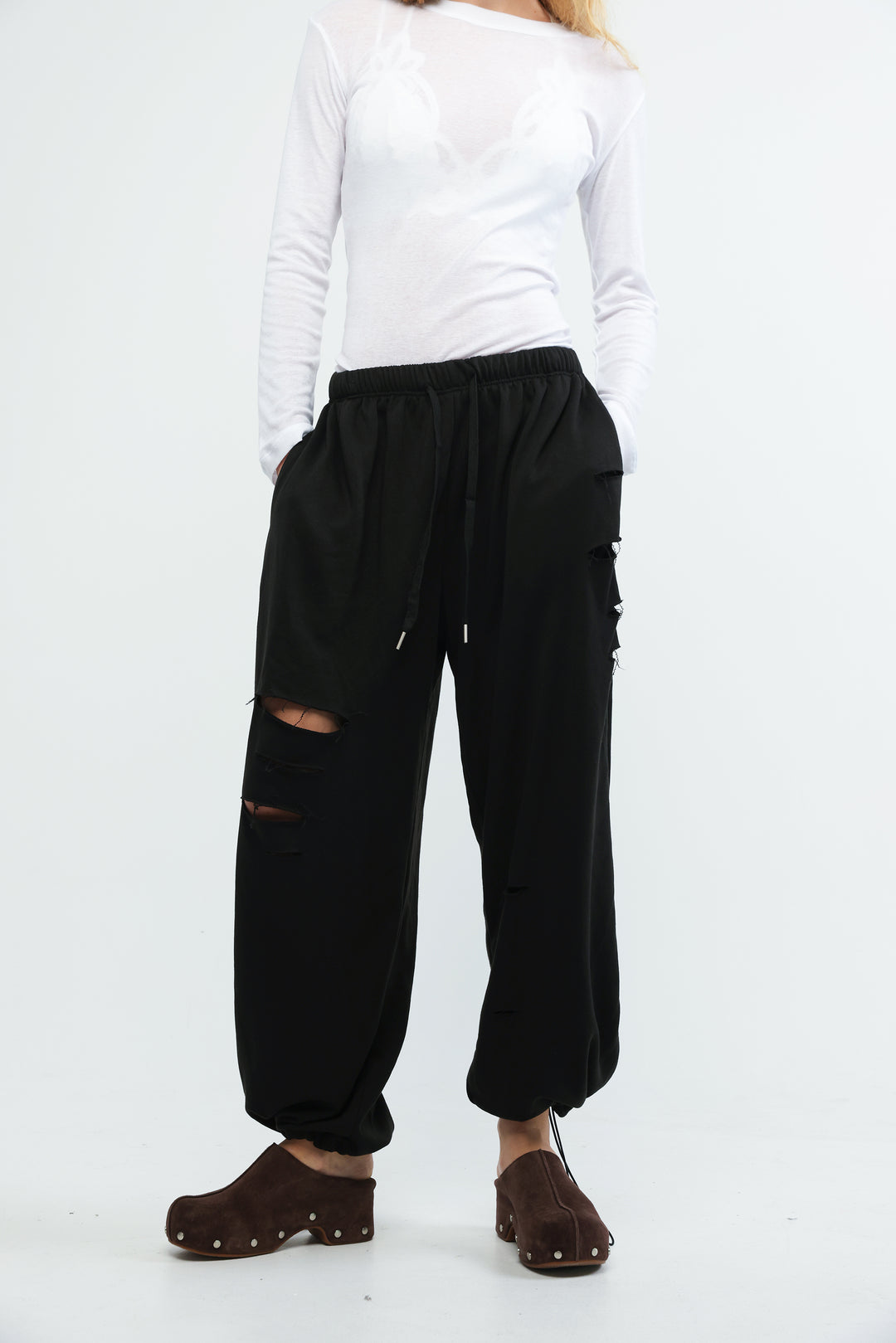 Black cargo joggers with ripped knee details and drawstring waist shown from front view