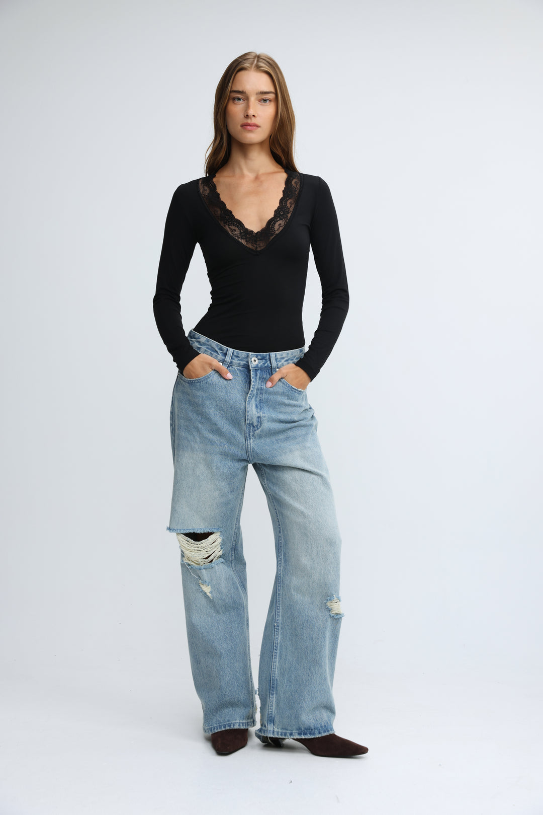 Black long-sleeved shirt with delicate lace trim at the neckline shown from the front