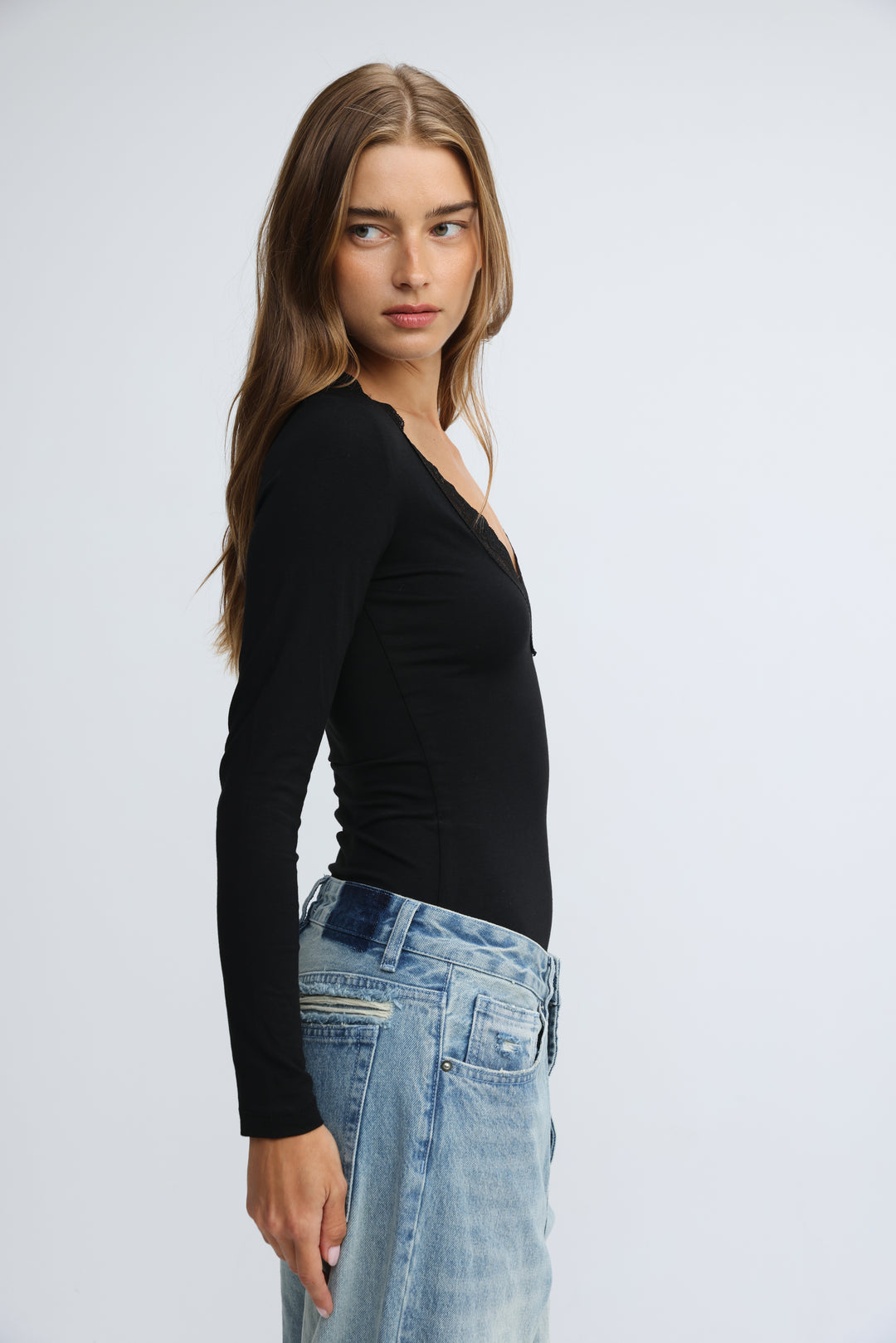 Black long-sleeved shirt with subtle v-neckline and fitted silhouette shown from the front in the mysterious black shirt