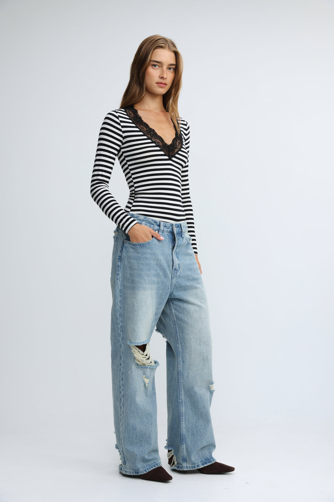 Black and white striped long-sleeve top with black lace v-neckline shown from the front