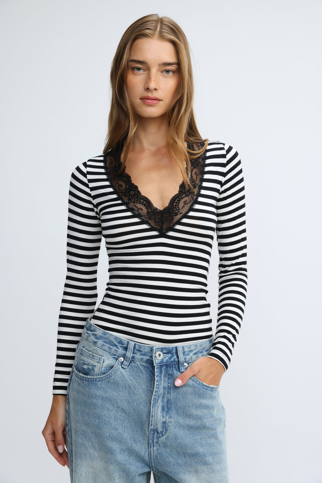 Mysterious black striped shirt with long sleeves and black lace v-neckline shown from the front