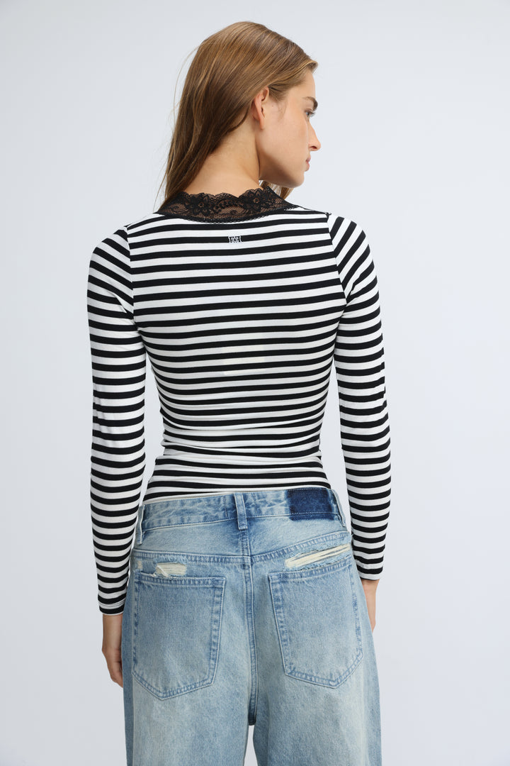 Black and white striped long-sleeved shirt with a black lace collar shown from the front