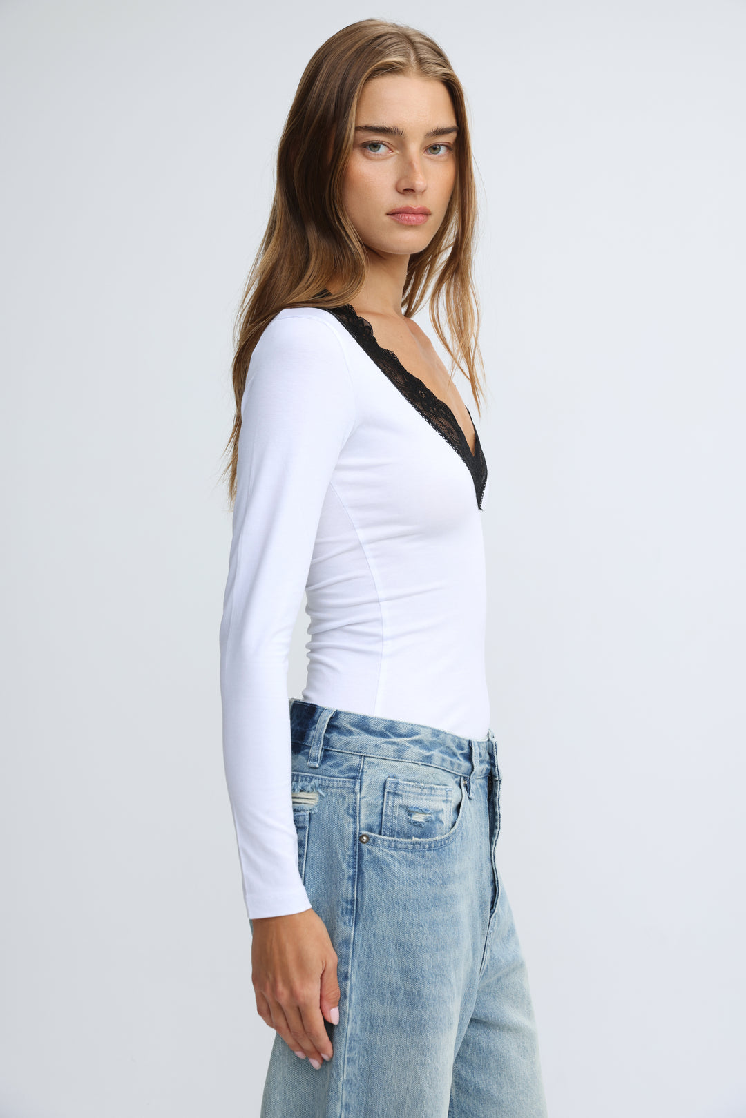 White long-sleeved shirt with black lace trim at the neckline shown from the front titled Mysterious White Shirt