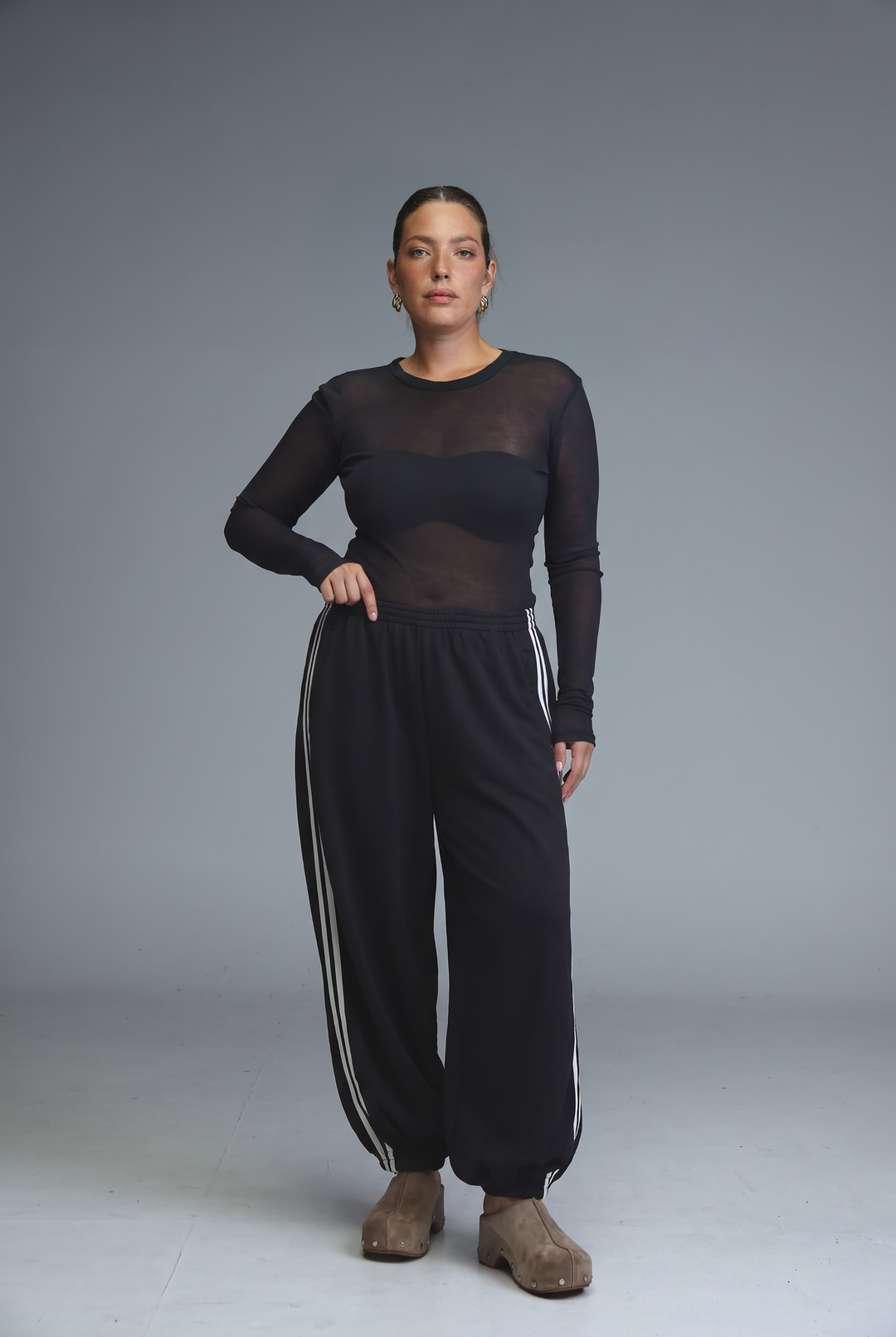 Black ballooning joggers with leopard stripes and white side stripes shown from the front