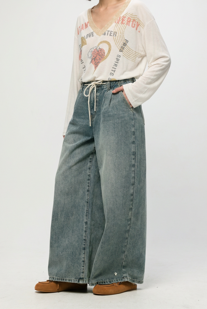 Wide-leg star 461 blue denim pants in faded blue wash with drawstring waistband shown from the front