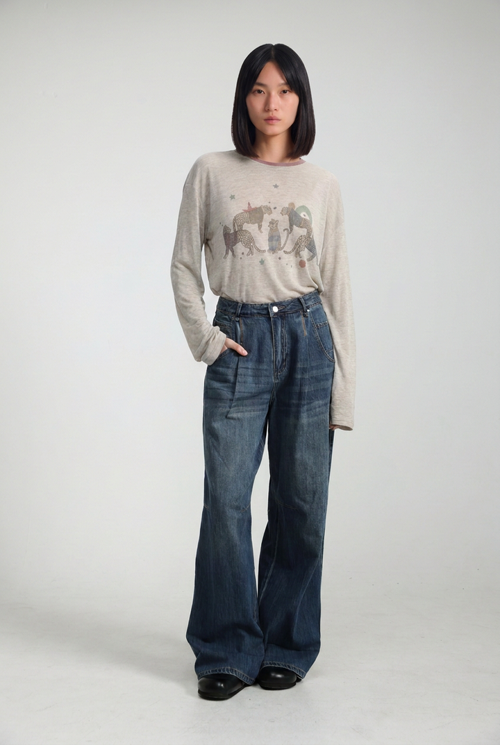Beige long-sleeved sweater with subtle embroidered animal motif on the chest shown from the front