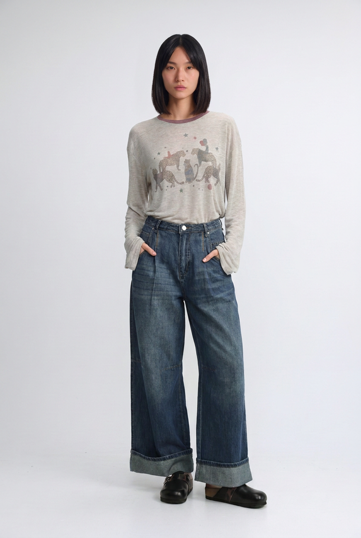 Star 535 blue denim soft long-sleeved beige sweater with subtle gray animal print across the chest front view