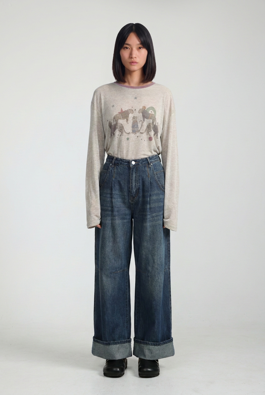 Beige long-sleeved tee with whimsical unicorn and sloth graphic print shown from the front in star 535 blue denim collection