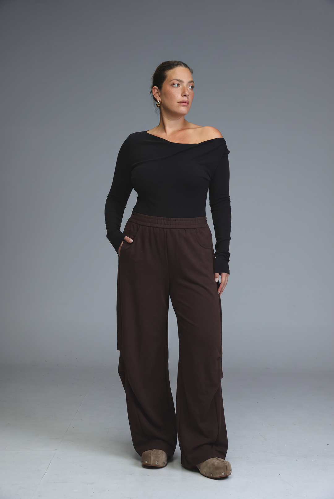 646 black joggers are wide-leg pants with a relaxed fit and visible side cargo pockets shown from the front