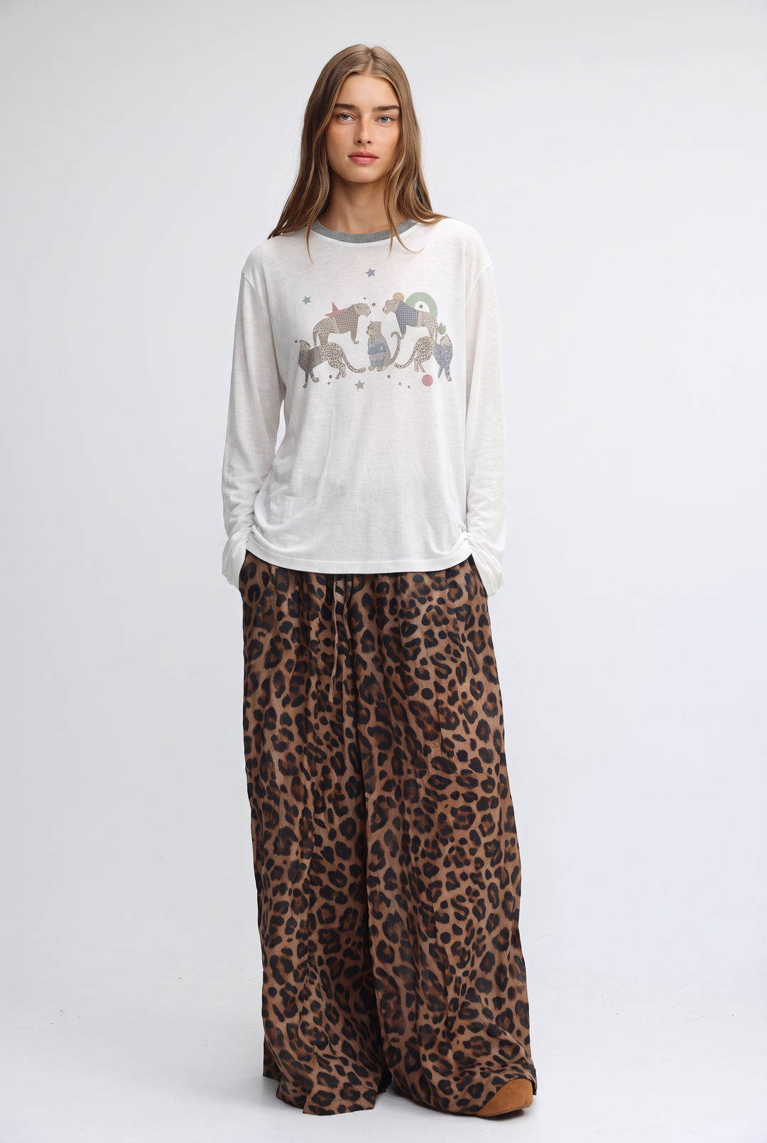 White jungle cream long-sleeved top with gray crew neckline and silver gray pink stylized animal print on front