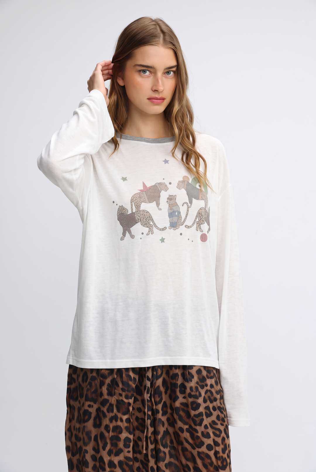 White long-sleeved jungle cream shirt with gray trim and cat graphic accented by stars and glitter details