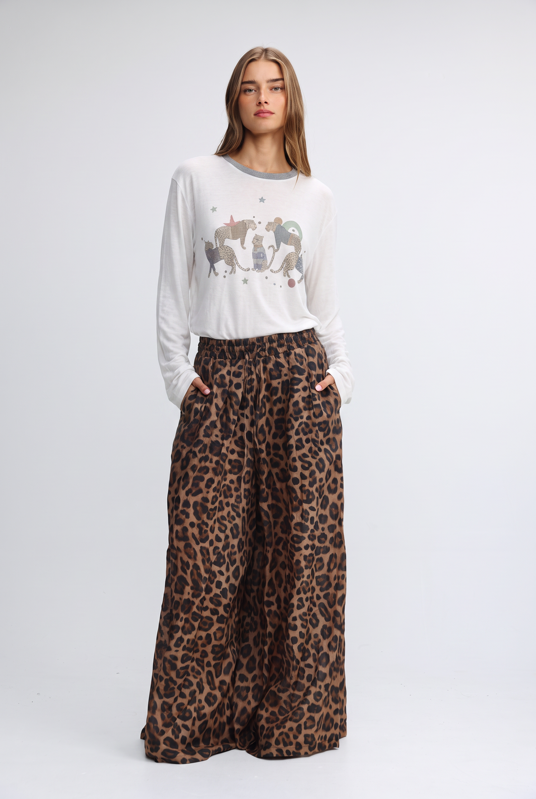 A woman wears a front view white long-sleeved jungle cream shirt with gray trim and embroidered animal designs