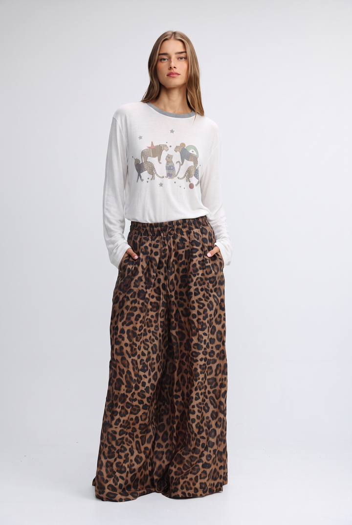 A woman wears a front view white long-sleeved jungle cream shirt with gray trim and embroidered animal designs
