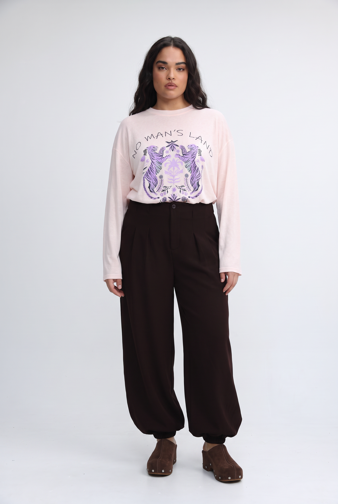 Nml pink soft long-sleeved sweatshirt with purple and white unicorn graphic and no mans land text on front