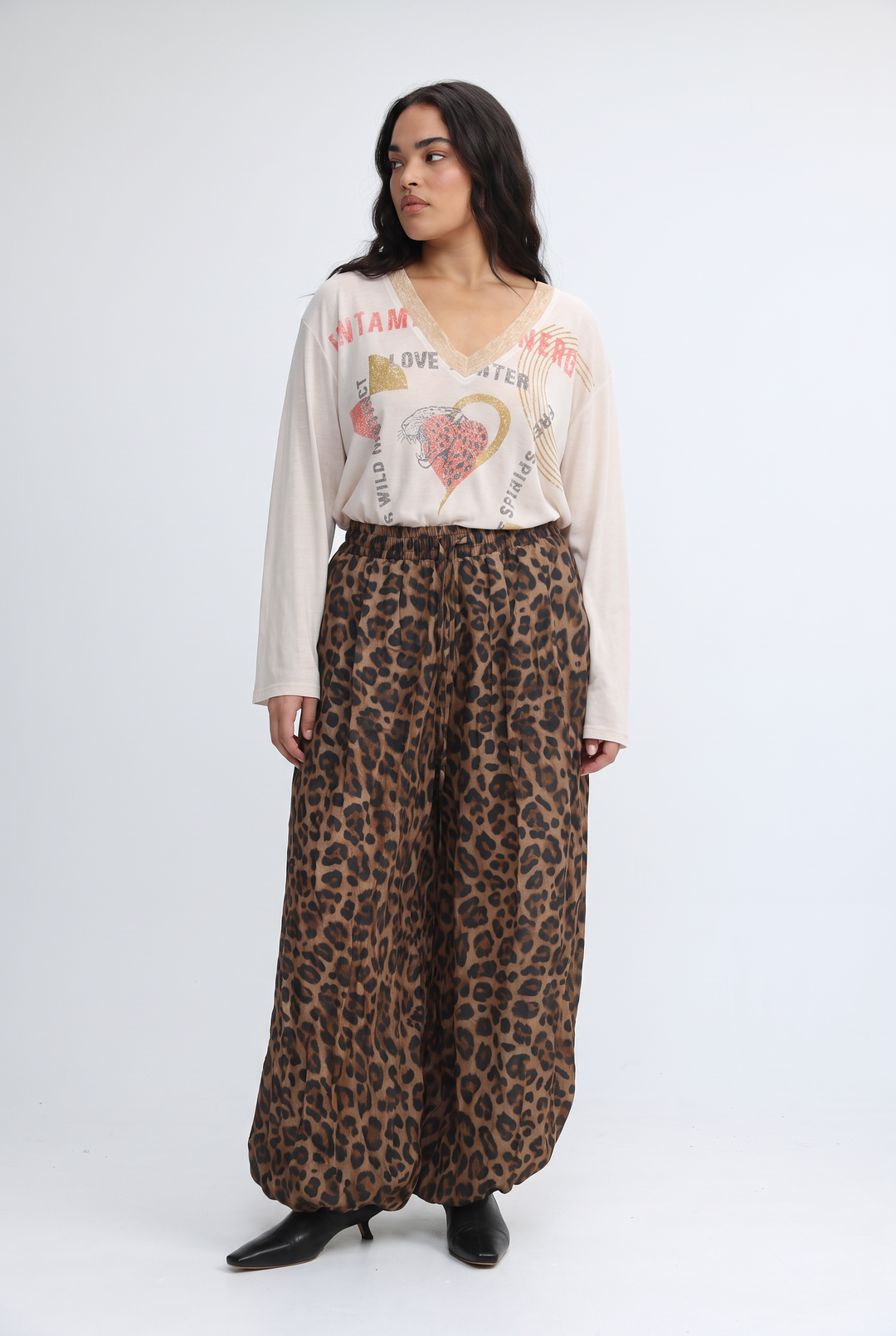 Jungle Purple v shirt paired with leopard-print wide-leg pants in a flowing earthy-toned fabric shown front view
