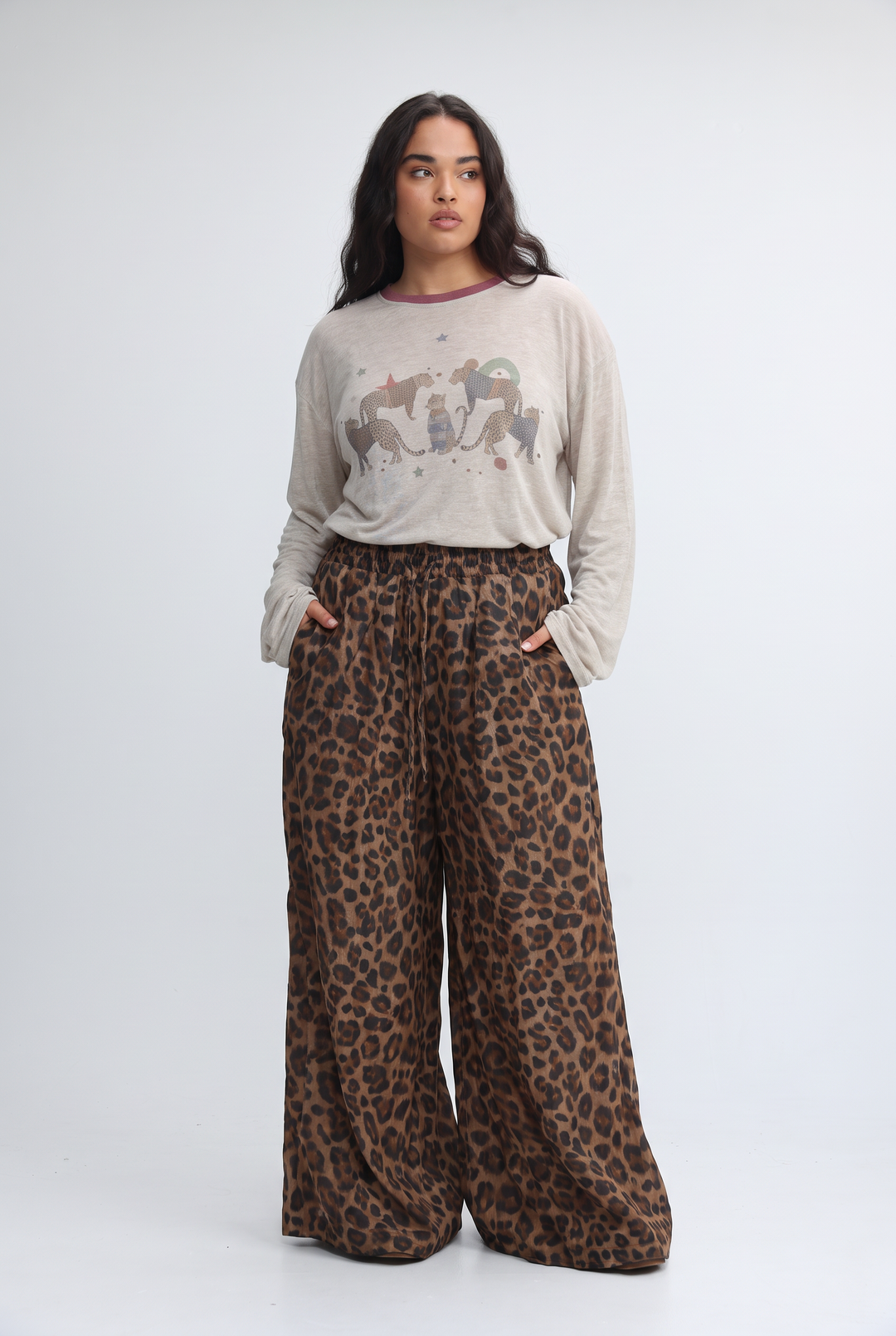 Wide-leg cream leopard-print pants with elastic waistband in a flowing earth-toned fabric shown from the front
