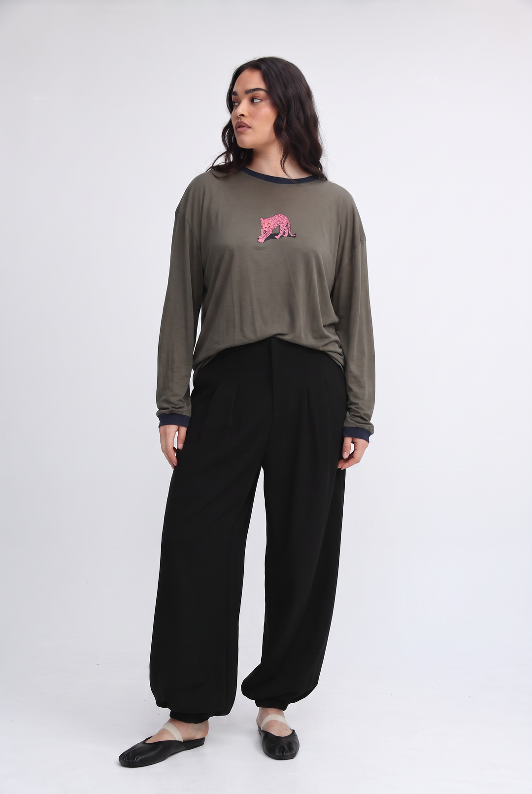 Olive green long-sleeved top with pink embroidered tiger on chest and navy blue ribbed cuffs shown from front