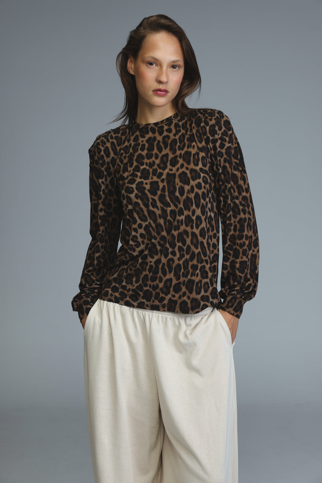 Lg leopard padded shirt showing a long-sleeved leopard-print blouse with a high neckline and gathered cuffs front view