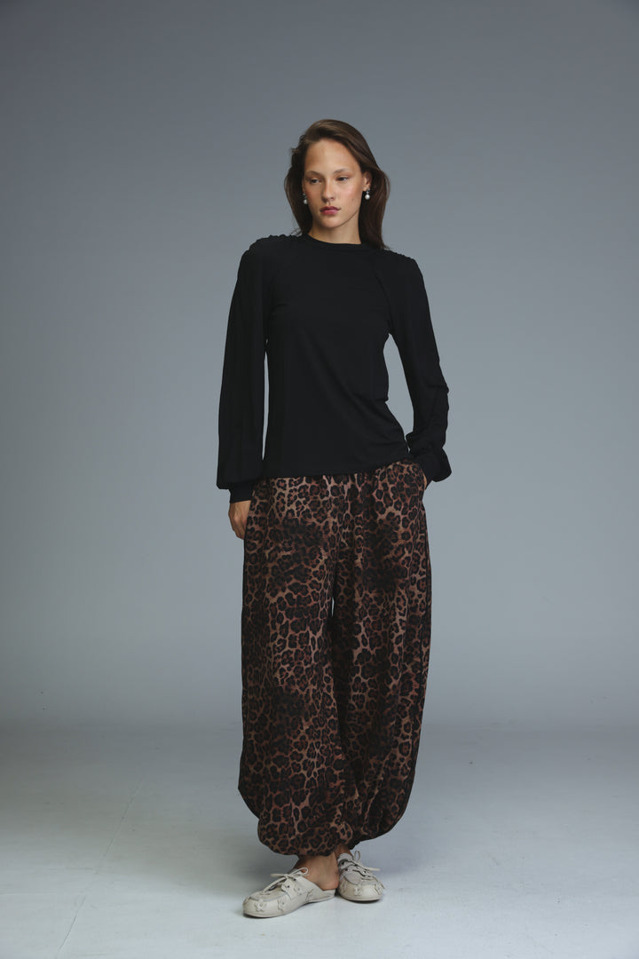 Black padded shirt long-sleeved top with ruffled shoulders shown from the front