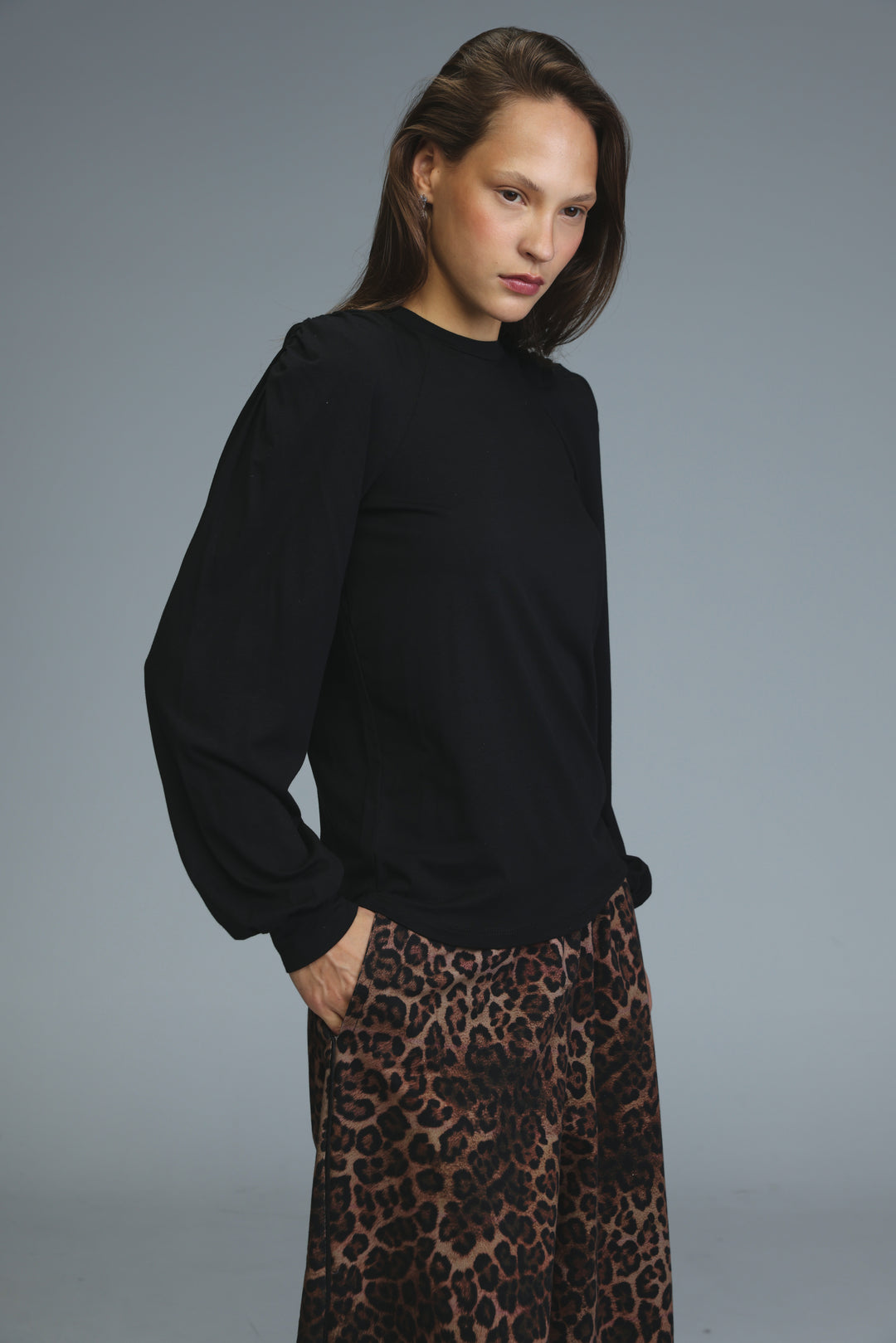 Lg black padded shirt with long sleeves, relaxed fit, and subtle texture shown from the front