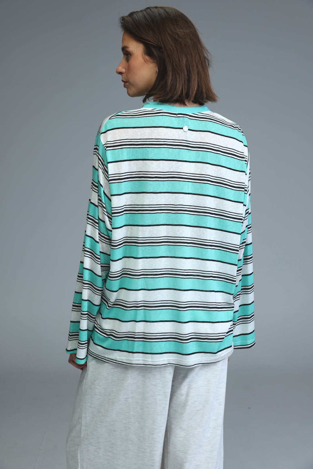 Glow mint striped long-sleeved shirt with horizontal stripes in mint green white and black shown from the front
