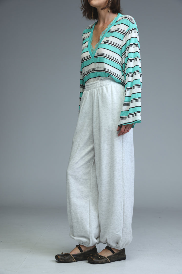 Light grey joggers with loose fit and elastic cuffs shown from the front