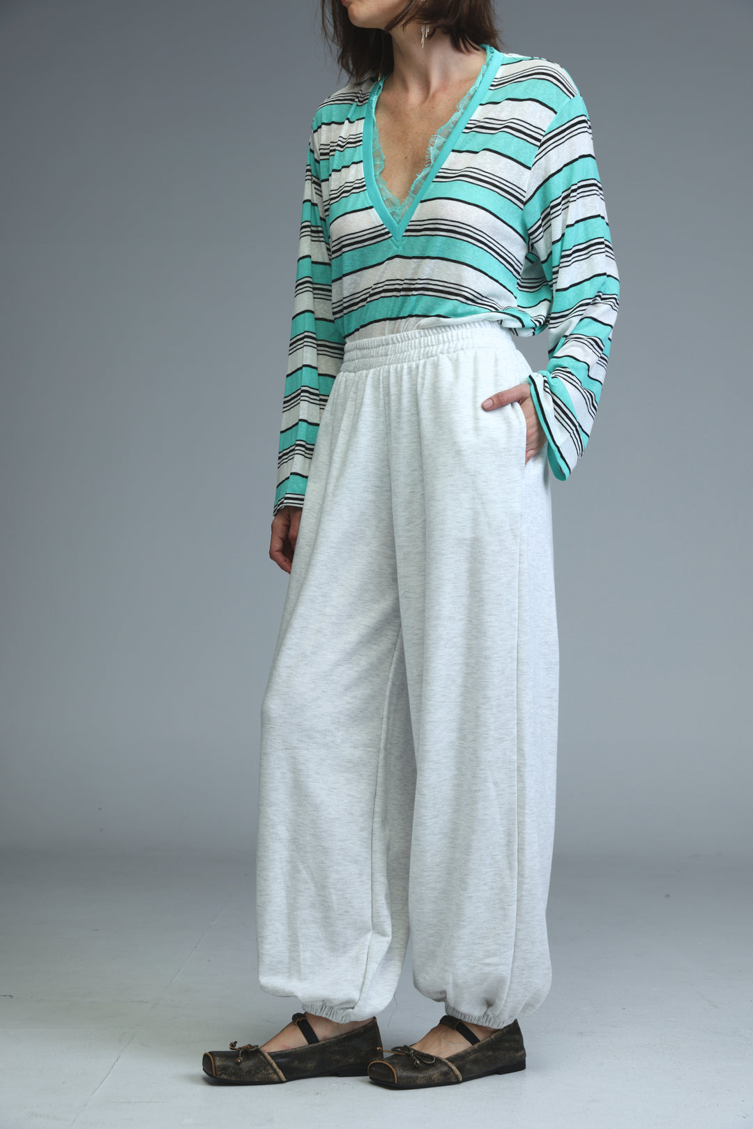 Try light grey joggers with wide-leg fit elastic waistband and drawstring cuffs shown from front view
