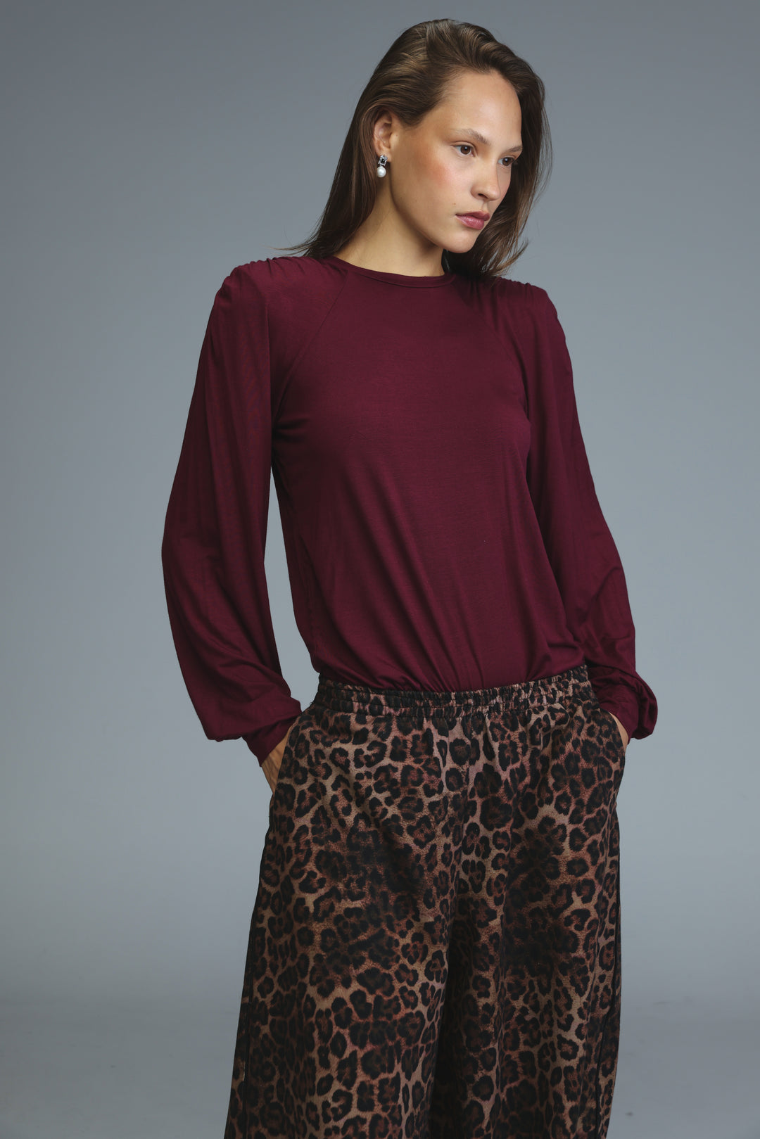 Burgundy long-sleeved wine padded shirt with round neckline and gathered fabric at the shoulders front view