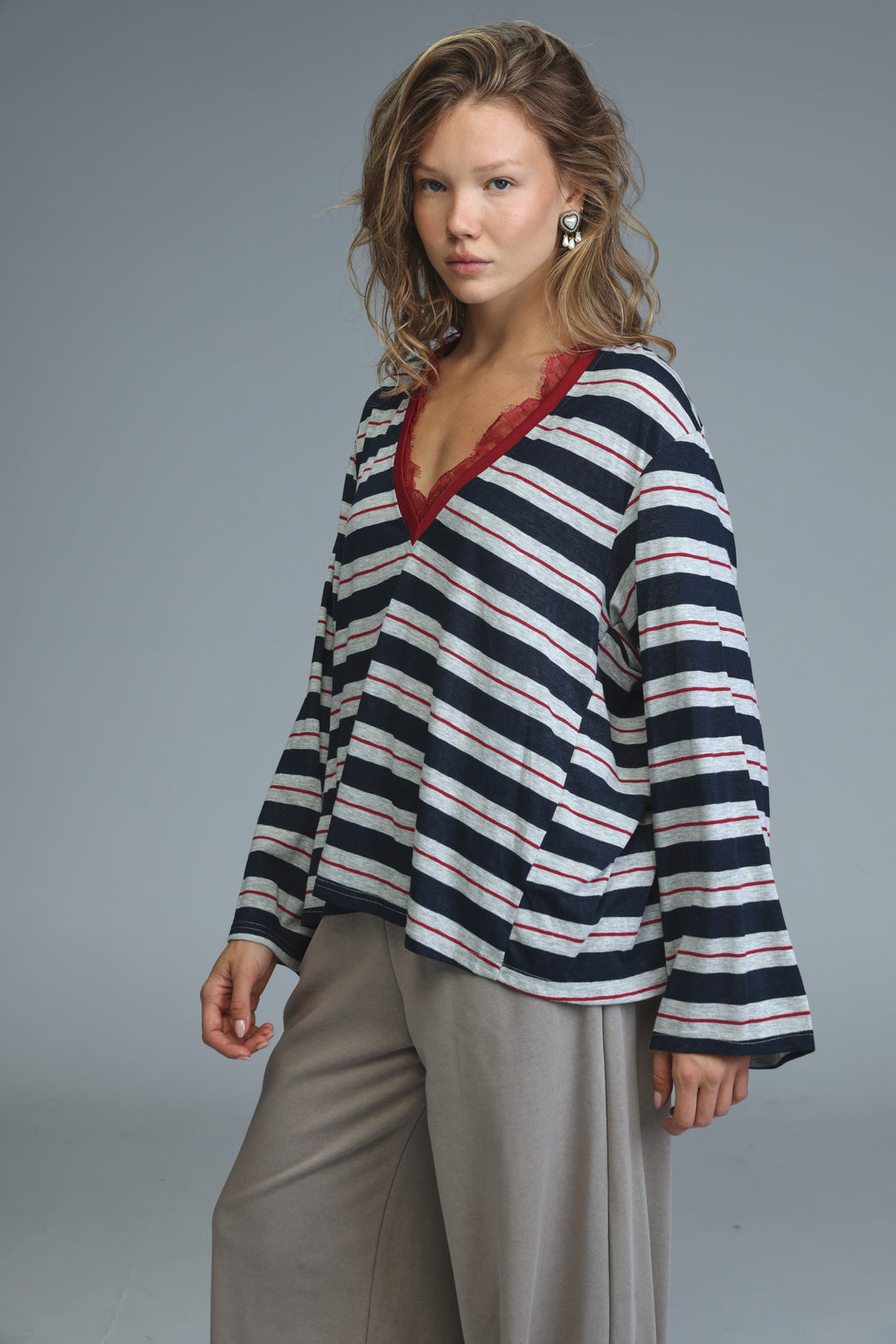 Navy blue striped long-sleeved v-neck shirt with white and red stripes and lace trim on the neckline