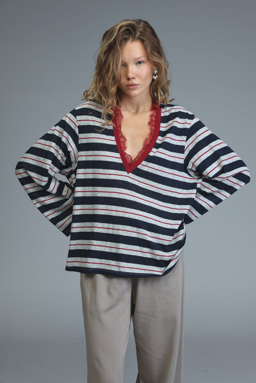Glow blue striped shirt with navy and white stripes and a red lace-trimmed v-neckline shown from the front