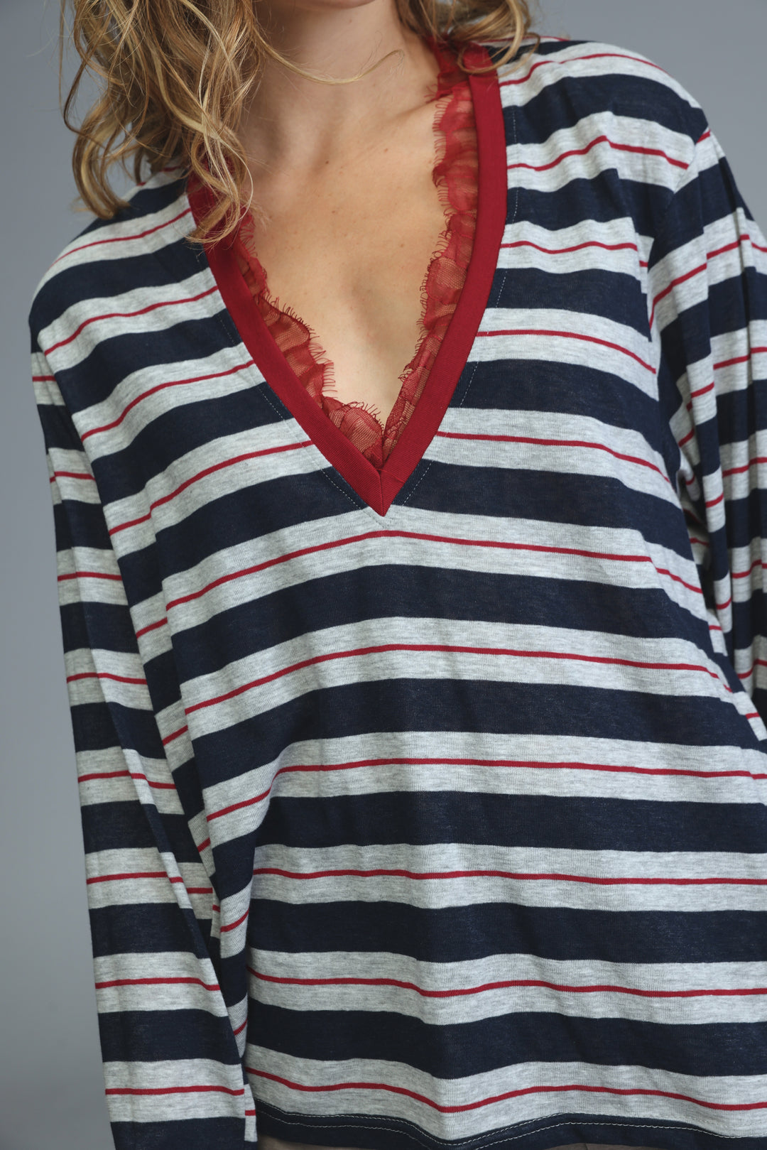 Glow blue striped shirt long-sleeved top with navy white red stripes and contrasting red lace trim at v-neckline front view
