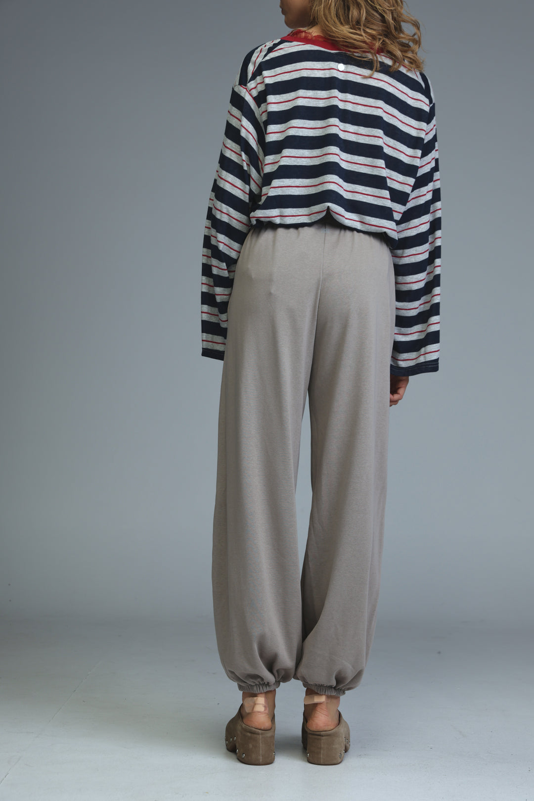 Try beige joggers in loose-fitting wide-leg style with elastic cuffs shown in light gray front view