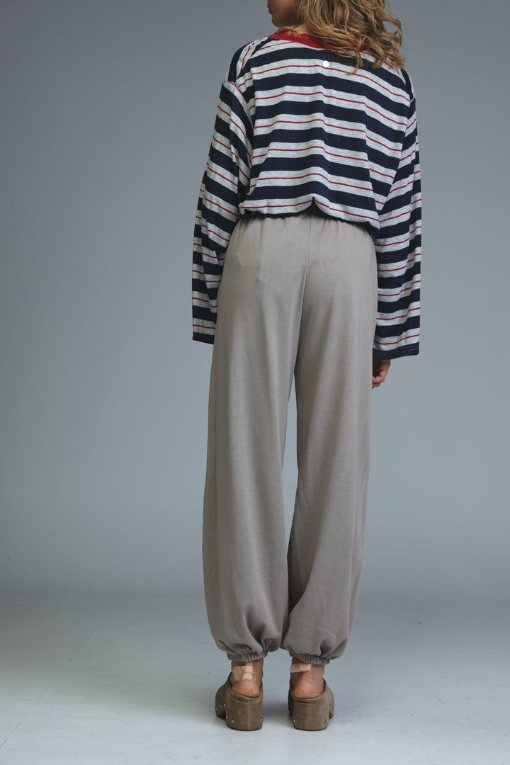 Try beige joggers in loose-fitting wide-leg style with elastic cuffs shown in light gray front view