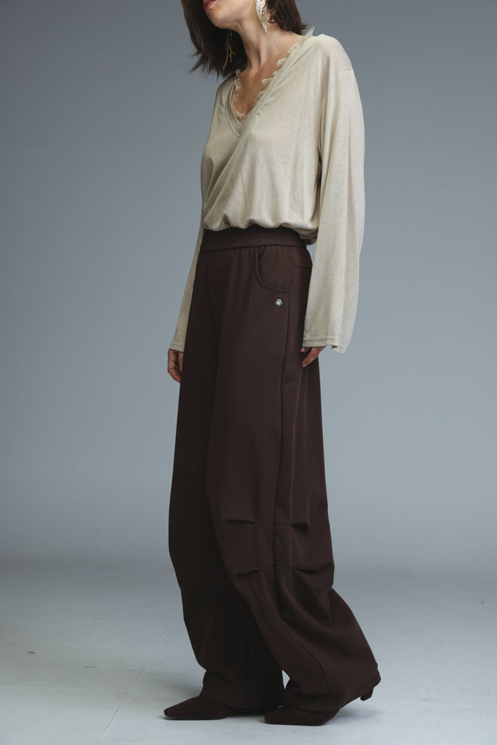 The 646 brown joggers feature wide-leg dark brown trousers with an elastic waistband and subtle side pockets