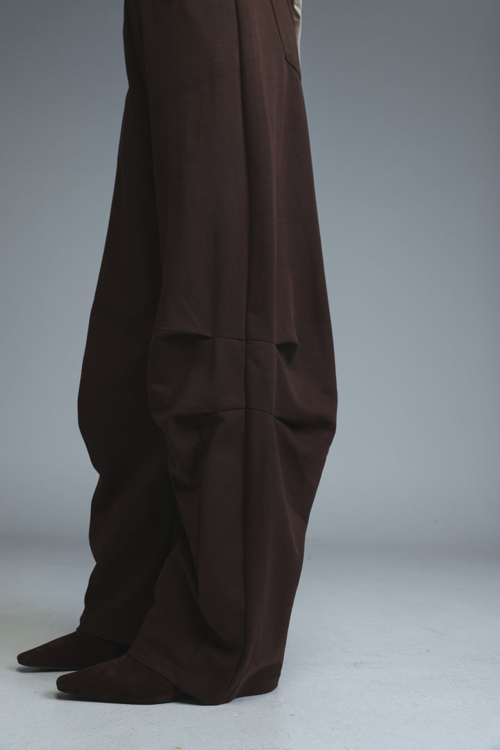 Dark brown 646 joggers with wide legs, relaxed fit, and subtle front pleats shown from the front view
