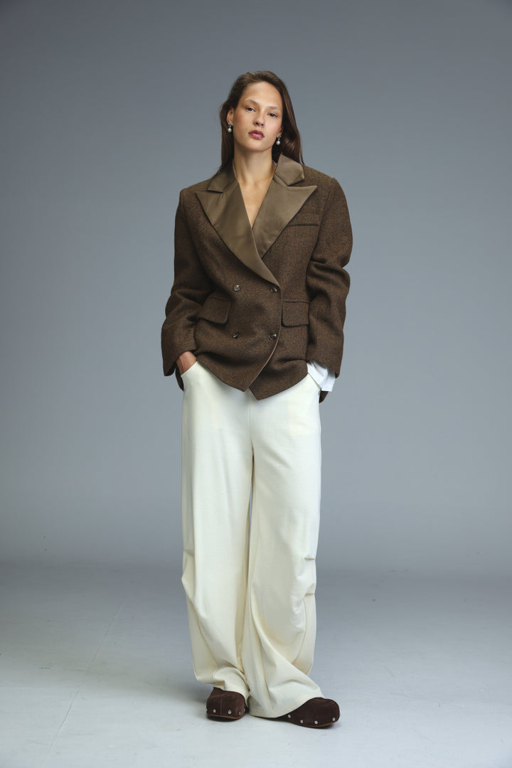 Brown double-breasted blazer with structured silhouette and satin lapels shown from the front