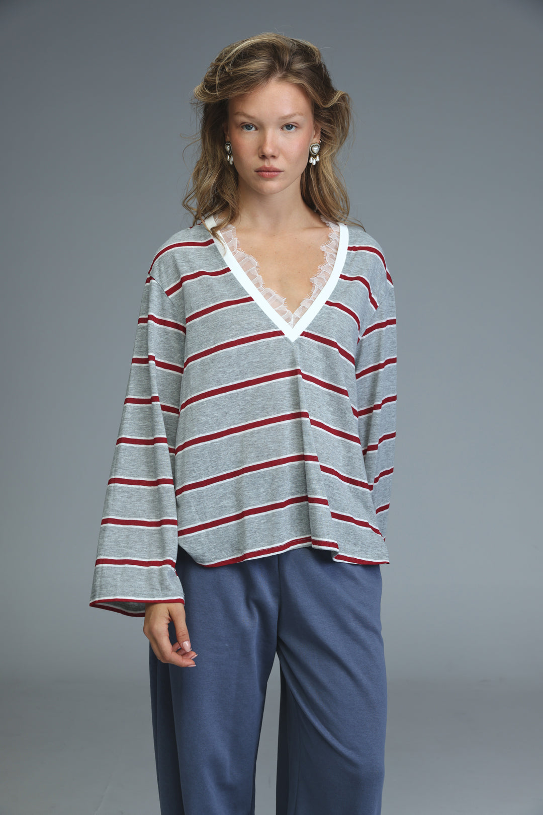 Glow grey striped shirt with soft gray and red horizontal stripes and white lace trim along the v-neck front