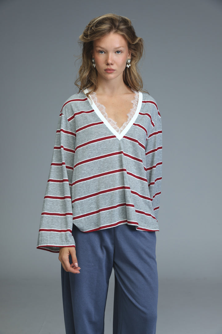 Glow grey striped shirt with soft gray and red horizontal stripes and white lace trim along the v-neck front