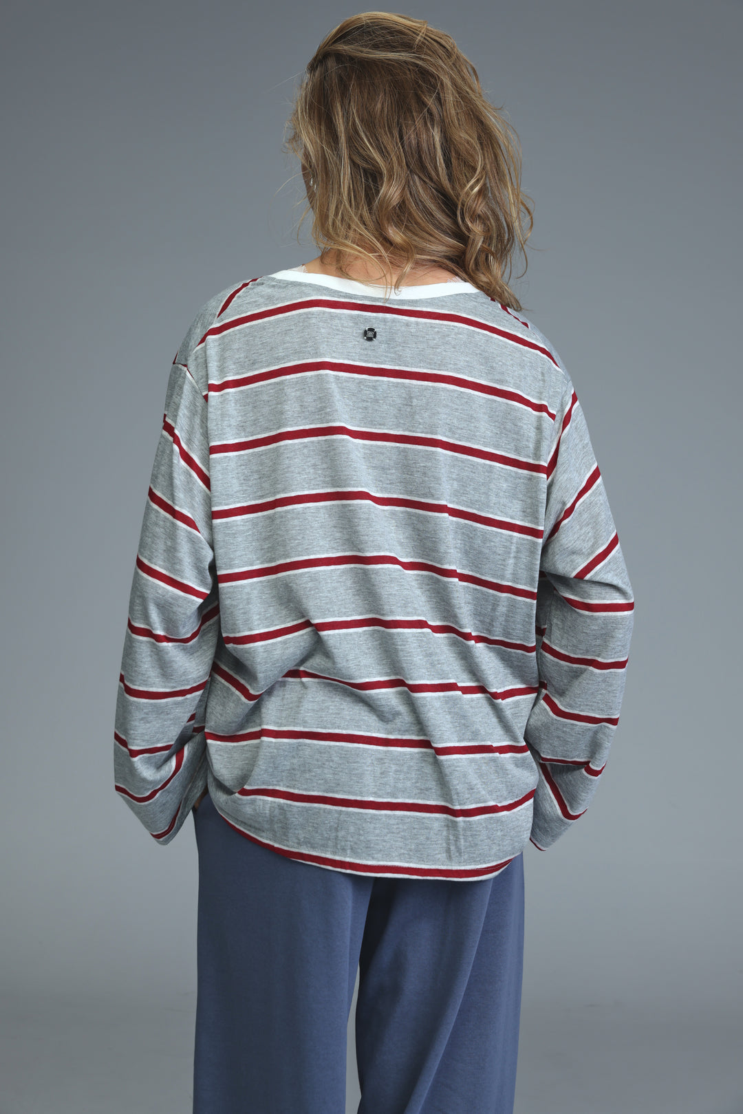 Glow grey striped shirt with gray and red horizontal stripes and a white crew neck long-sleeved front view
