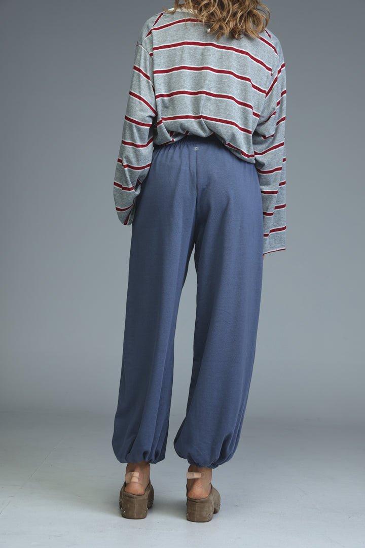 Blue wide-leg joggers with a relaxed flowing silhouette and elasticated cuffs shown from the front view