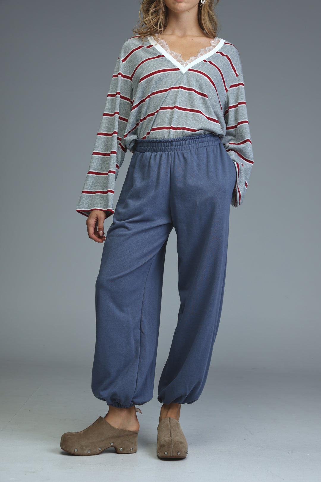 Blue joggers with elastic waist, relaxed tapered fit, and drawstring cuffs shown from the front