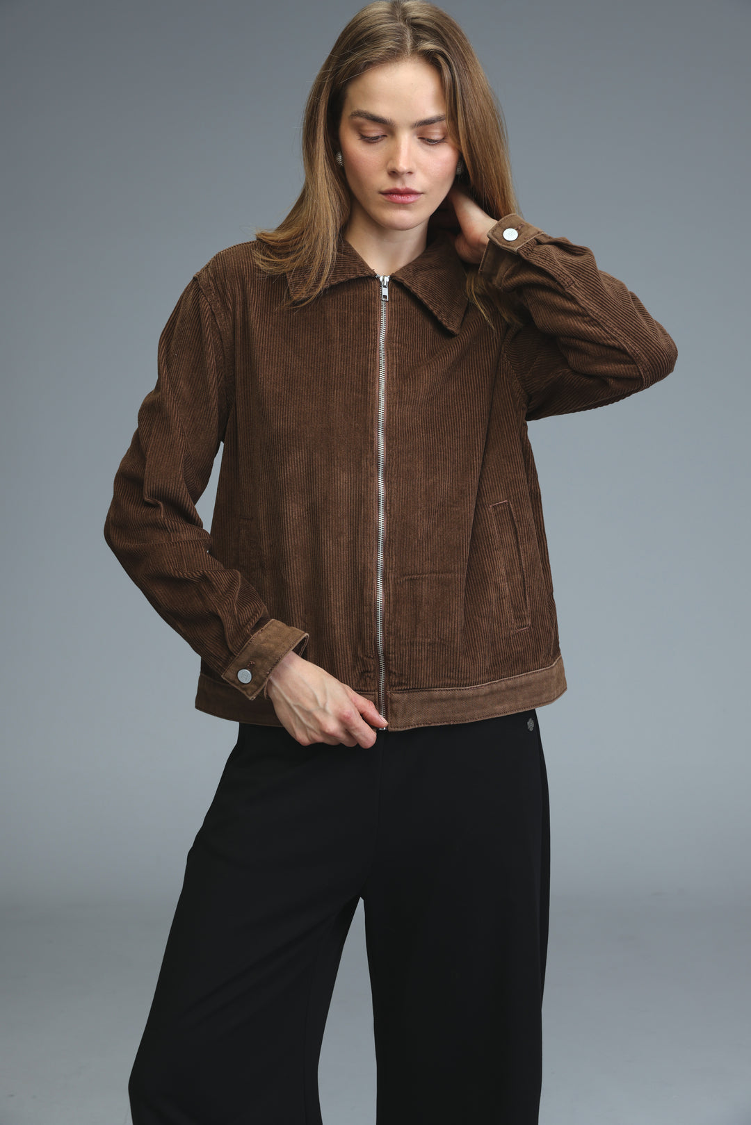 Brown corduroy jacket with front zipper and buttoned cuffs shown from the front view