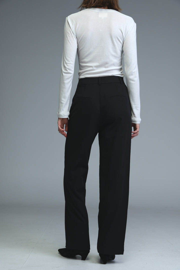 Black mid rise tailored bottoms with high waist and straight leg fit shown from the front view